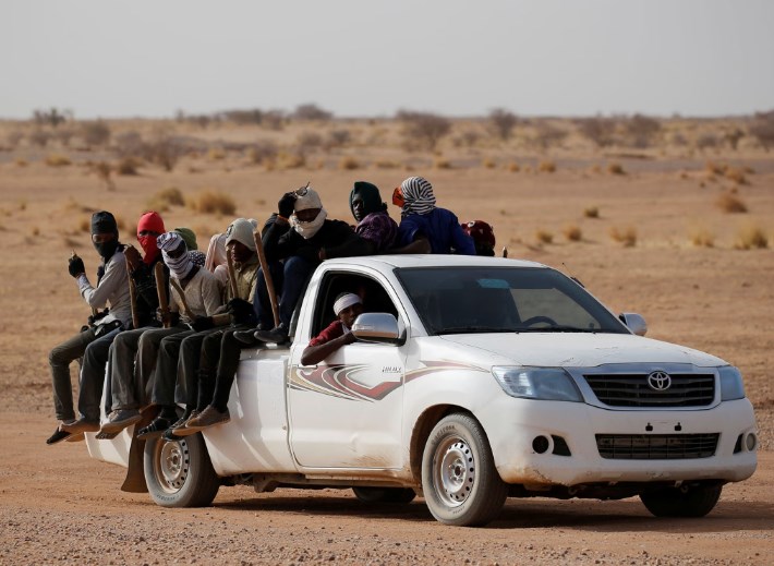 Forty-nine people die of dehydration after truck breaks down in the Sahara.